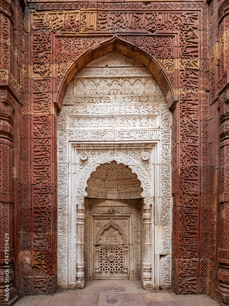 Detail of Qutub Minar in Delhi, India. It is the tallest free-standing stone tower in the world, and the tallest minaret in India, built with red sandstone and marble in 1199 AD.