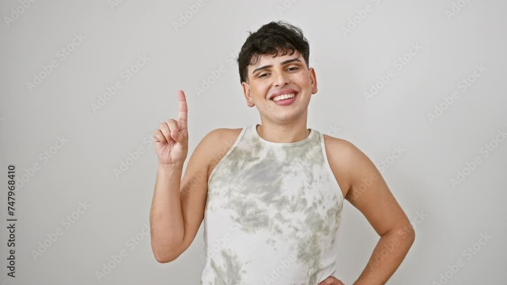 Young man wearing sleeveless t shirt standing showing and pointing up with finger number one while smiling confident and happy. over isolated white background Young man wearing sleeveless t shirt standing showing and pointing up with finger number one while smiling confident and happy. over isolated white background