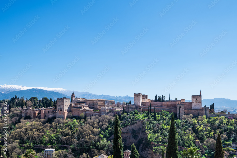 Panorama view of the Alhambra in Granada on a clear Spring day, a palace and fortress complex that remains one of the most famous monuments of Islamic architecture.