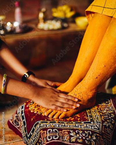 Haldi ceremony is a ritual in Indian weddings where turmeric paste is smeared on the bride's body by family and friends