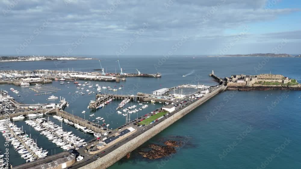 St Peter Port Guernsey aerial shot out towards Castle Cornet and across to Herm showing commercial port ferry terminal and marinas St Peter Port Guernsey aerial shot out towards Castle Cornet and across to Herm showing commercial port ferry terminal and marinas