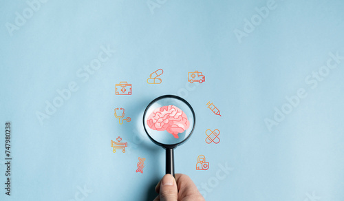 Принти на полотні Magnifying glass focuses on human brain icon, prevention, health care or awareness of Alzheimer's, Parkinson's disease, dementia, stroke, mental health