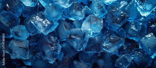 Dark Room with Blue Light Illuminating a Large Pile of Blue Ice Cubes Cool and Refreshing Conceptual Still Life Photo