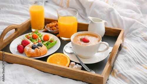Good morning. Tray with tasty breakfast on bed, top view 