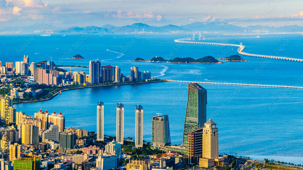 Aerial view of beautiful coastline and modern city buildings landscape at sunset in Zhuhai. High Angle view.