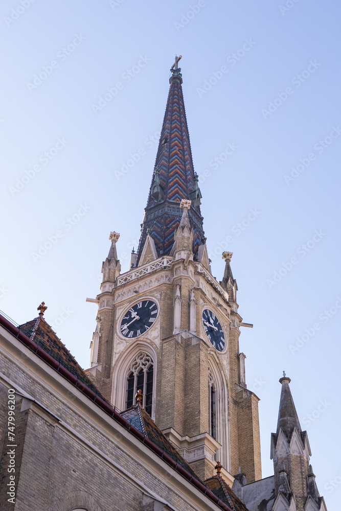Roman Catholic church in Novi Sad, Serbia, blending neo-Gothic architecture with historical charm,  in the city center, inviting tourists to explore its cultural and religious significance .