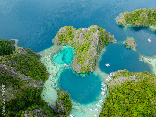 Lagoons with corals. Boats over turquoise water in Kayangan Lake. Coron, Palawan. Philippines.