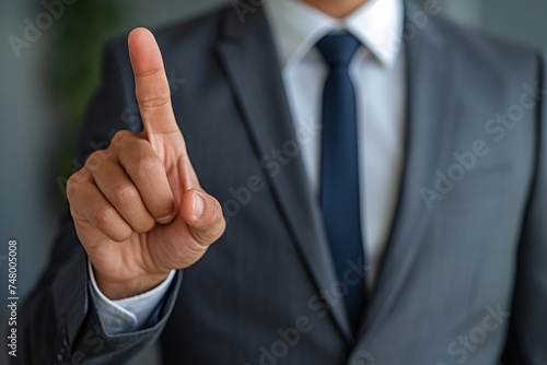 a person in a suit pointing up