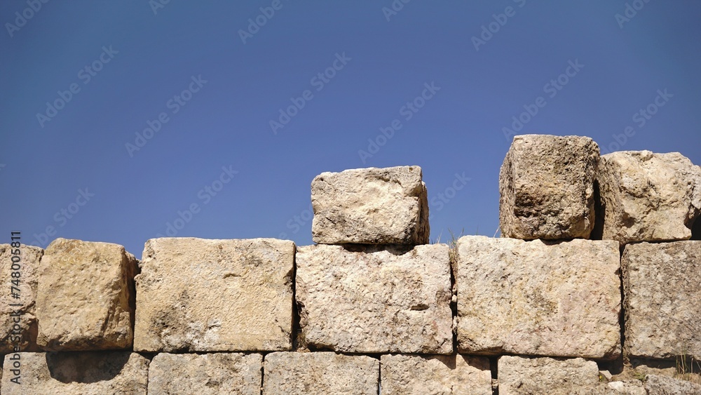 large stones in rustic wall against the sky