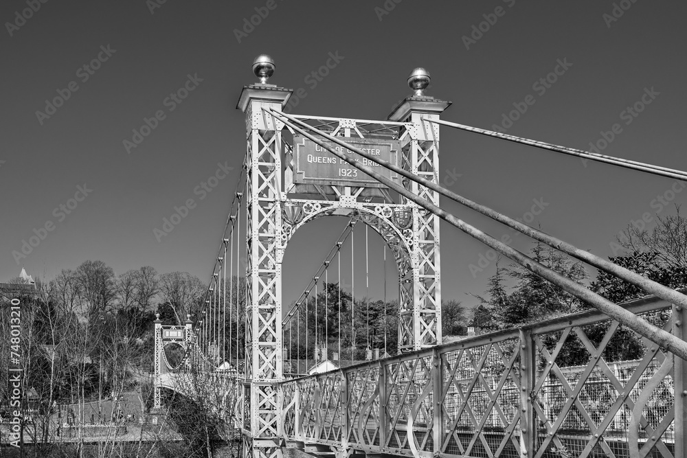Obraz premium Queens Park Suspension Bridge 1923 footbridge crossing the river Dee at the Groves in Chester, Cheshire, England, UK in black and white