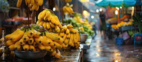 A collection of fresh yellow bananas arranged neatly on a wooden table. The bananas are vibrant in color and ready to be enjoyed as a healthy snack.