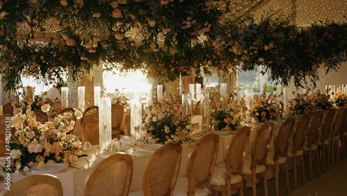 Wedding reception dinner decorations Dinner table setup sunset background. Close up decoration flowers candles Boho style. Romantic wedding reception party