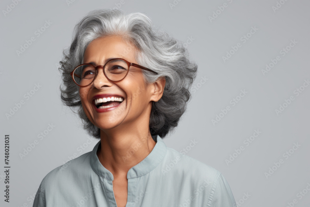 Portrait of a senior Indian ethnic woman with a cheering face