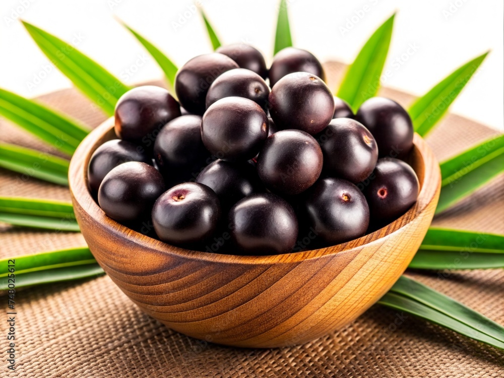 acai berry fruit with leaf in a bowl