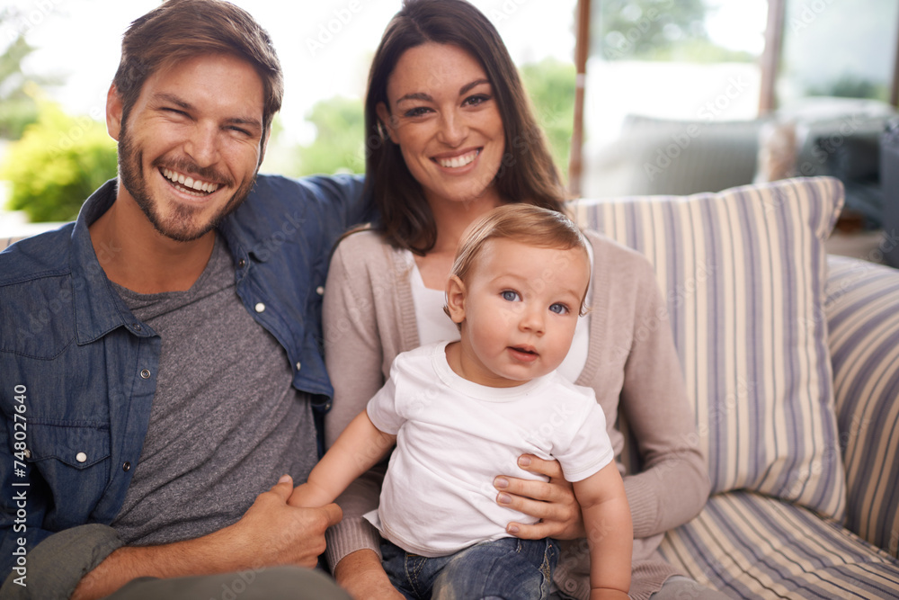 Parents, happy family or portrait of baby in house for support, security or bonding in living room. Relax, boy or toddler with mom or father for love or care for child development, wellness or growth Parents, happy family or portrait of baby in house for support, security or bonding in living room. Relax, boy or toddler with mom or father for love or care for child development, wellness or growth