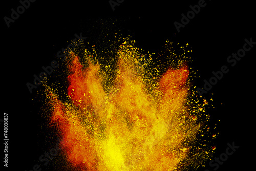 Abstract powder splatted background. Colorful powder explosion on black background. Colored cloud. Colorful dust explode. Freeze motion of yellow color powder exploding 