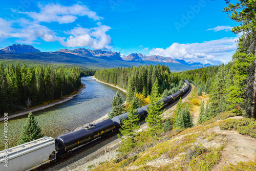 Long freight train moving along Bow river in Canadian Rockies ,Banff National Park, Canadian Rockies,Canada. photo