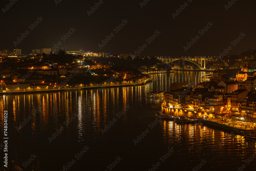 Night view of Douro river and Porto city, Portugal.