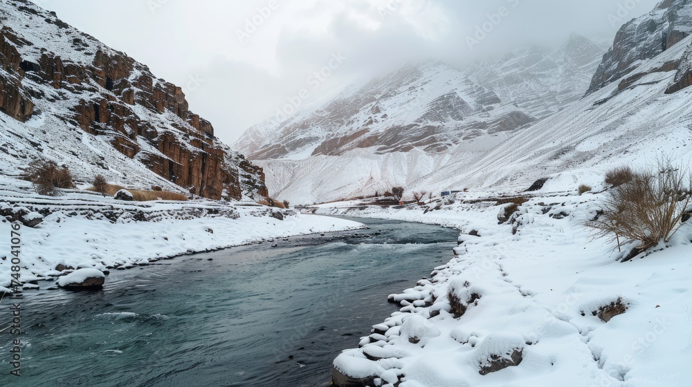 Snowy river flowing through mountain pass