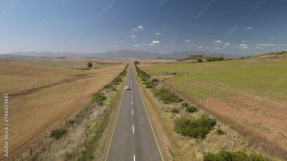 Fly over across South African straight desert road with blue sky background Fly over across South African straight desert road with blue sky background