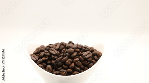 Black coffee beans placed in a cup 