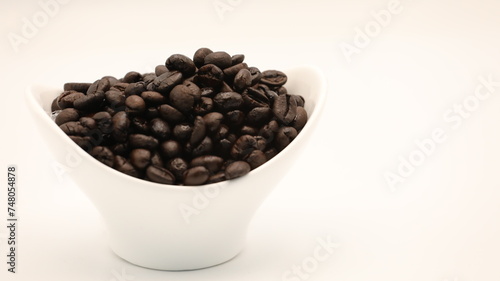 Black coffee beans placed in a cup 