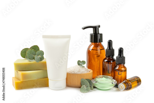 Beautiful spa composition with eucalyptus leaves isolated on white background. Beauty and fashion spa concept with body cream  scrub  mask  essential oil and sea salt.Cosmetic product.