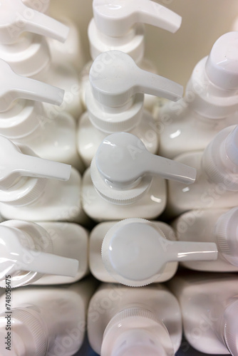 Artistically arranged shampoo dispenser caps on a shelf, symbolizing elegance and hair care. Perfect for beauty and hygiene product projects.
