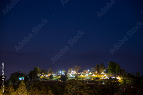 The view of twinkling lights from the many residential houses nestled on hills. © kaentian