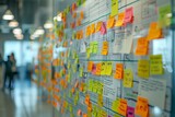 Organized sticky notes on a glass wall with a grid pattern used for planning in a corporate setting.