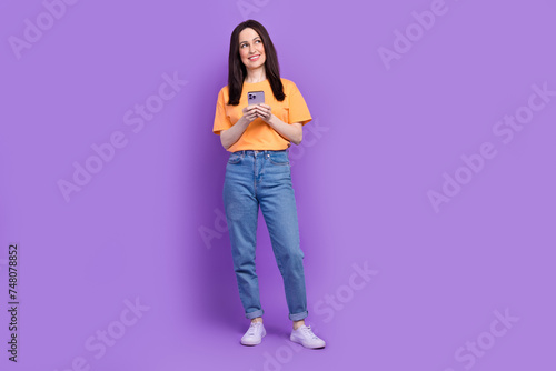 Full length photo of mature woman texting her assistant employee buy coffee look minded empty space isolated on purple color background