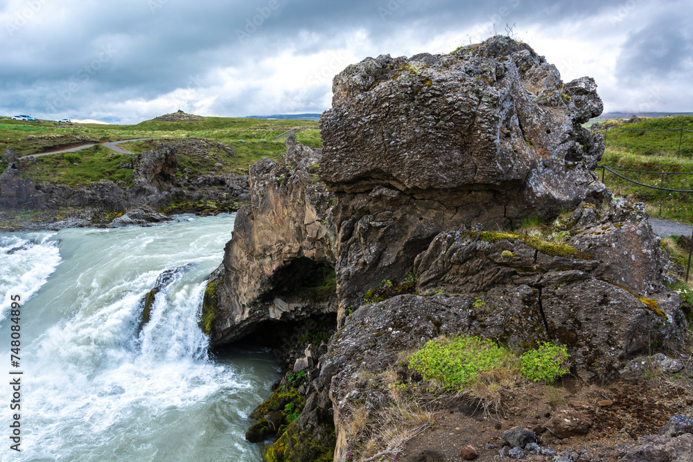 Icelandic landscape with a waterfall in the foreground, Iceland.