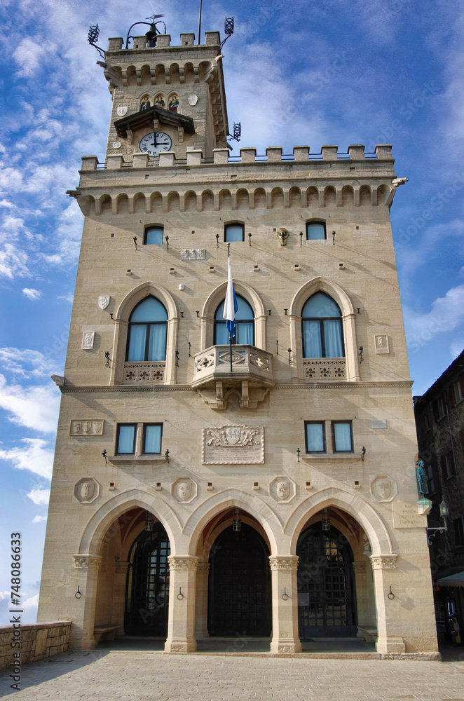Fototapeta premium The Government Palace of the Republic of San Marino with the flag of San Marino flying from the balcony in the central square of the city