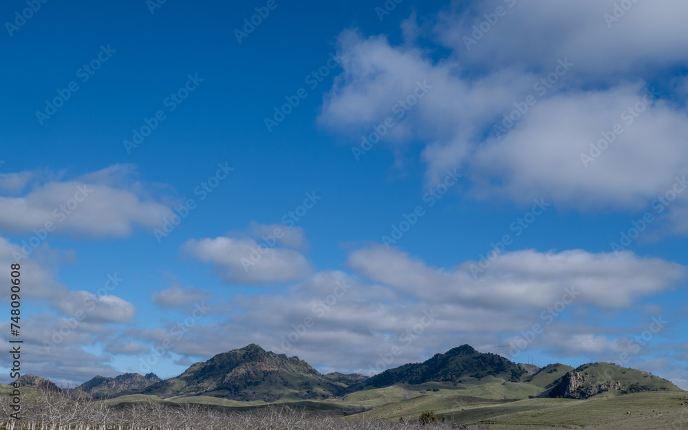 The Sutter Buttes, known as the Smallest Mountain Range, on a partly cloudy day and blue sky copy-space