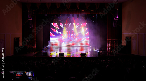 An empty stage of the theater  lit by spotlights and smoke before the performance