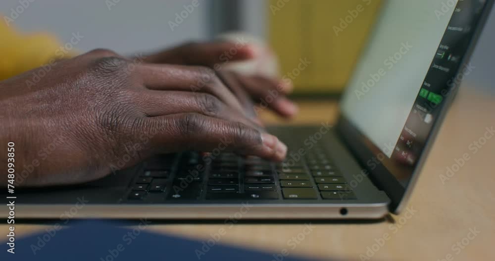 A man typing on a laptop keyboard, sitting at a desk in the office, close-up of his hands A man typing on a laptop keyboard, sitting at a desk in the office, close-up of his hands