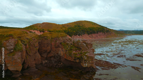 Rocky bay with swampy water. Clip. Amazing natural landscape with rocks in swampy sea bay. Rocky sea bay with algae