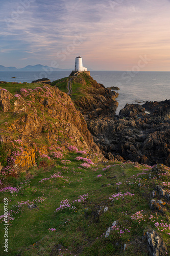 The majestic Twr Mawr lighthouse at sunset on the island of Ynys Llanddwyn in Anglesey, North Wales.