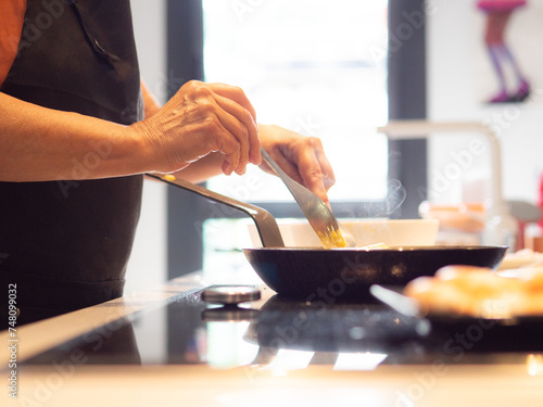 anonymous senior woman cooking