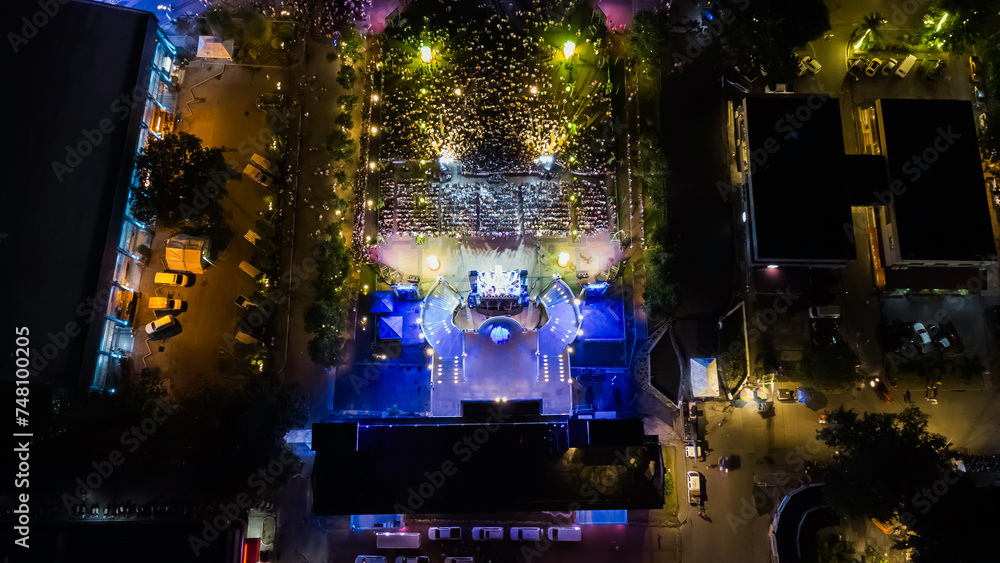 People at night open air concert aerial view