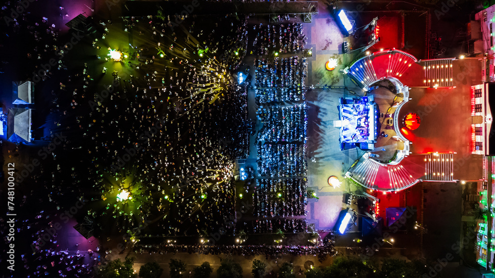 People at night open air concert aerial view