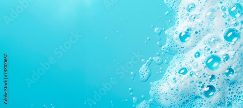 washroom background with foam and bubbles, on a blue bathroom surface, horizontal wallpaper wellnes, refreshment and cosmetics concept, copy space for text