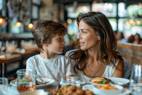 Happy Mother and Child Enjoying Meal Together in Cozy Restaurant Setting