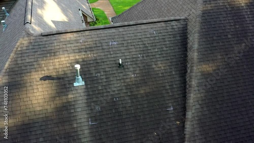 Roof with hail damage and markings from inspection photo