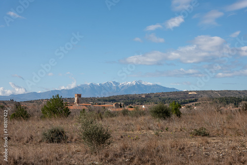 landscape of the mountains Le Canigou with the bell tower of Espira de l'Agly