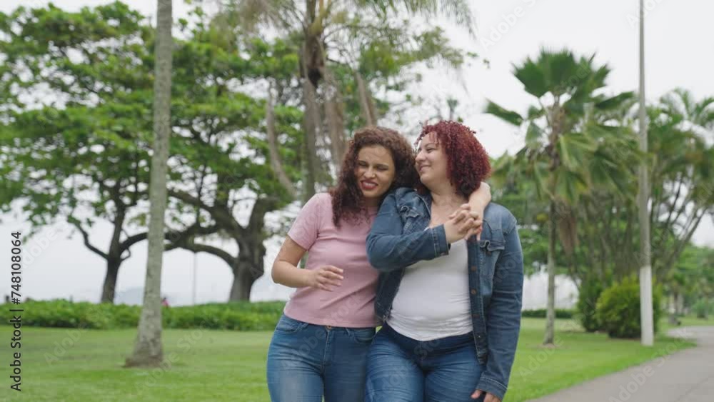 Gay lesbian couple walking down outdoors in love shown of affection in public. Free love to all sexual orientation. Lesbian young relationship.
Gay lesbian couple walking down outdoors in love shown of affection in public. Free love to all sexual orientation. Lesbian young relationship.
