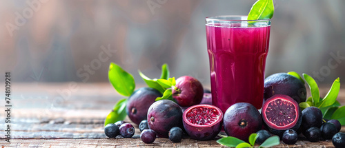 Fresh fig juice in a glass and fresh fruits on a wooden table