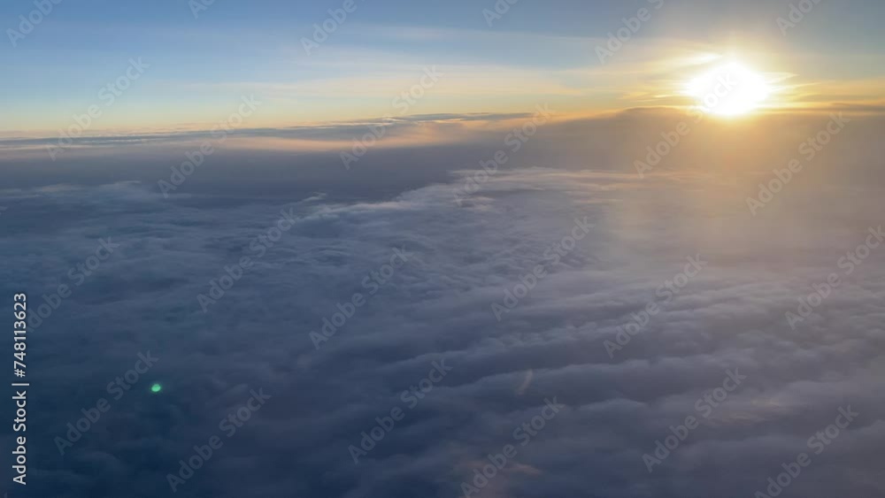 View from the airplane window to the clouds and beautiful sky View from the airplane window to the clouds and beautiful sky