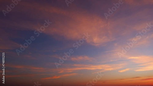 4K : Sunset sky time lapse : Timelapse video captures a sunset sky adorned with billowing clouds. Shades of pink, orange, and gold create a spectacle, painting the horizon.
 photo