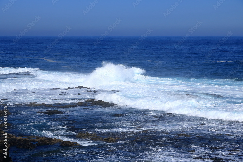 Stormy waves breaking on the stony beach in Fuerteventura in Jandia Natural Park